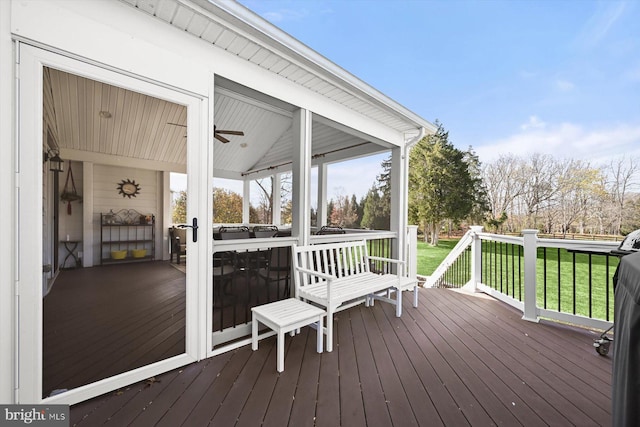 wooden deck featuring a lawn