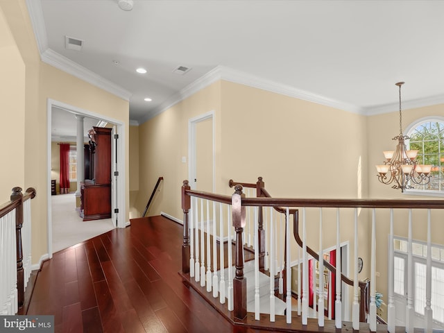 hall with dark hardwood / wood-style flooring, a notable chandelier, and crown molding