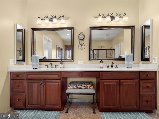 bathroom with tile patterned flooring, vanity, and a shower