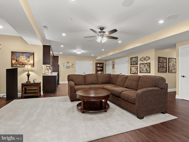 living room with dark hardwood / wood-style floors and ceiling fan