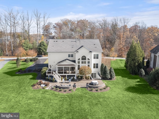 back of property with a patio, a sunroom, and a yard