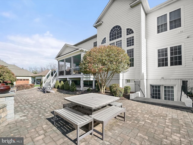 view of patio with a sunroom