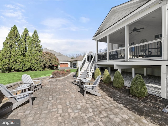 view of patio / terrace featuring a sunroom and ceiling fan