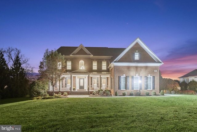 view of front of property featuring a porch and a yard