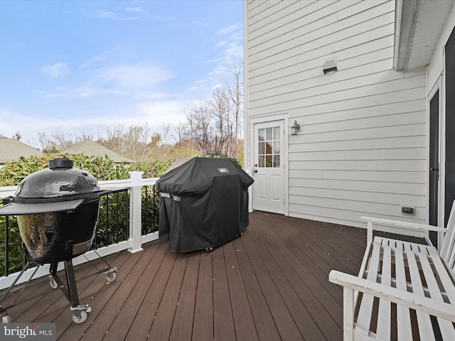 wooden terrace with a grill