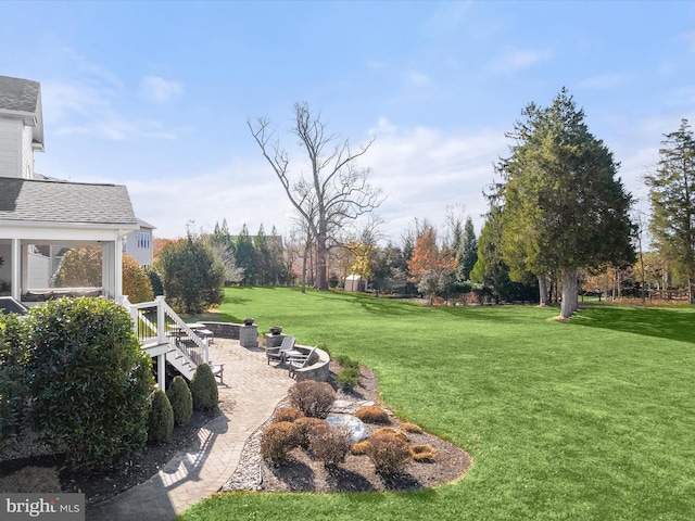 view of yard with a patio area and a fire pit