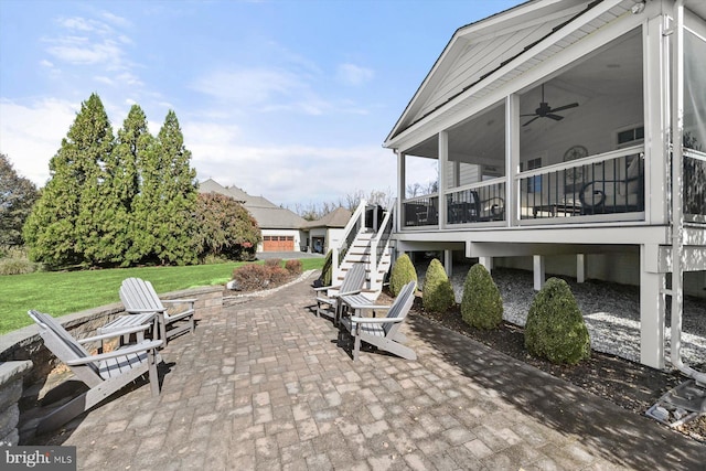 view of patio / terrace with a sunroom and ceiling fan