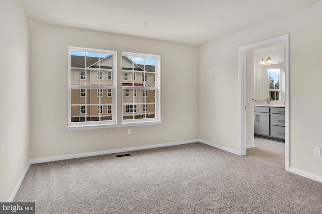 unfurnished room featuring light colored carpet