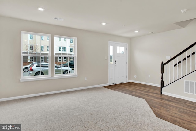 entrance foyer with dark hardwood / wood-style floors and a wealth of natural light