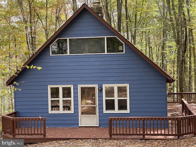 rear view of house featuring a deck