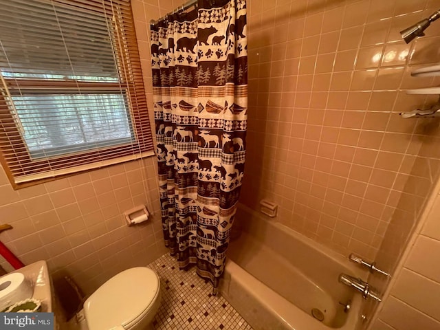 bathroom featuring tile walls, shower / bath combo with shower curtain, toilet, and tile patterned flooring