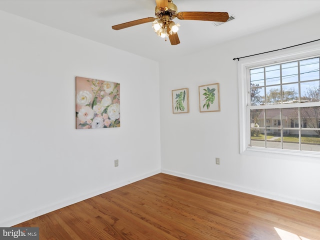 spare room with light wood-type flooring and ceiling fan