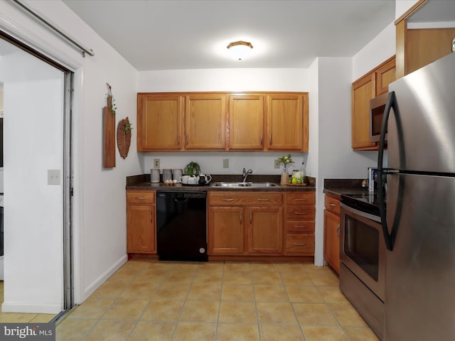 kitchen with sink, appliances with stainless steel finishes, and light tile patterned floors