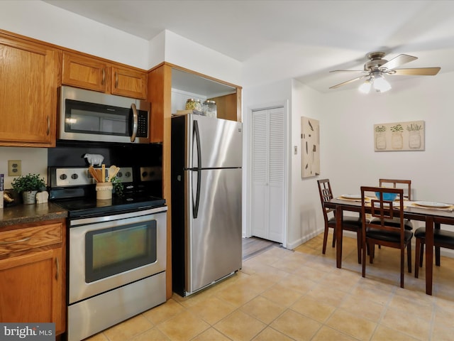 kitchen featuring appliances with stainless steel finishes, ceiling fan, and light tile patterned floors