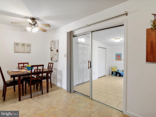 tiled dining area with ceiling fan