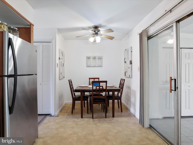 tiled dining room featuring ceiling fan