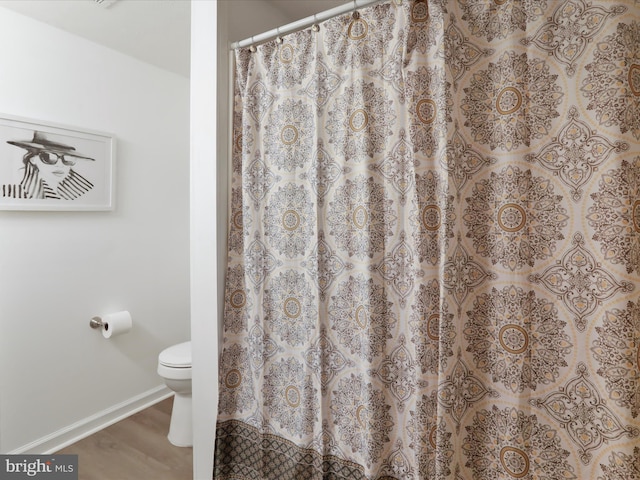 bathroom featuring hardwood / wood-style floors and toilet