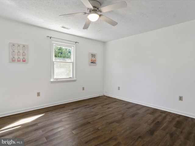 empty room with dark hardwood / wood-style floors, a textured ceiling, and ceiling fan