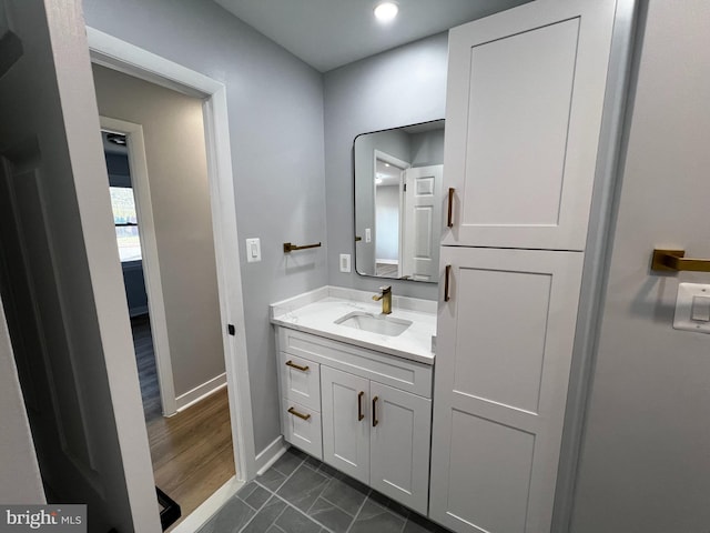 bathroom with vanity and wood-type flooring