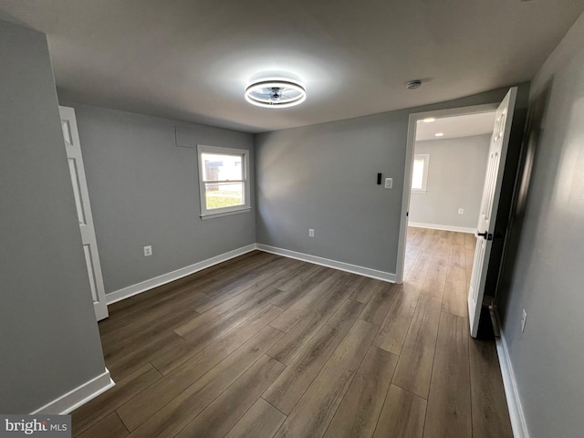 unfurnished room featuring dark wood-type flooring