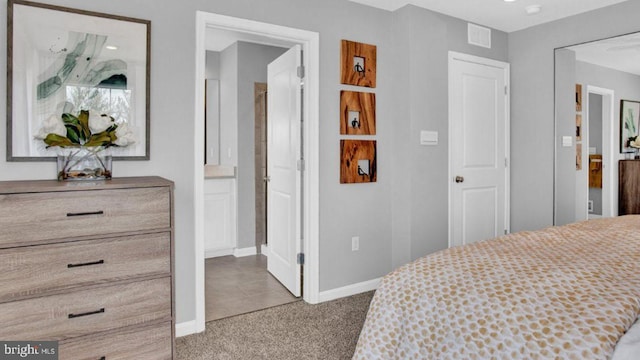 carpeted bedroom with ensuite bathroom