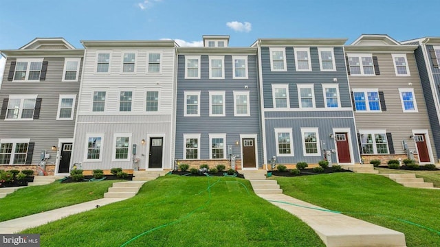 view of property featuring a front lawn