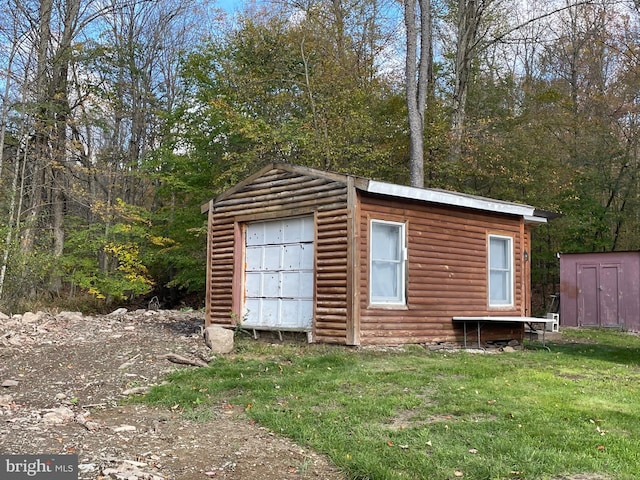 view of outbuilding with a lawn