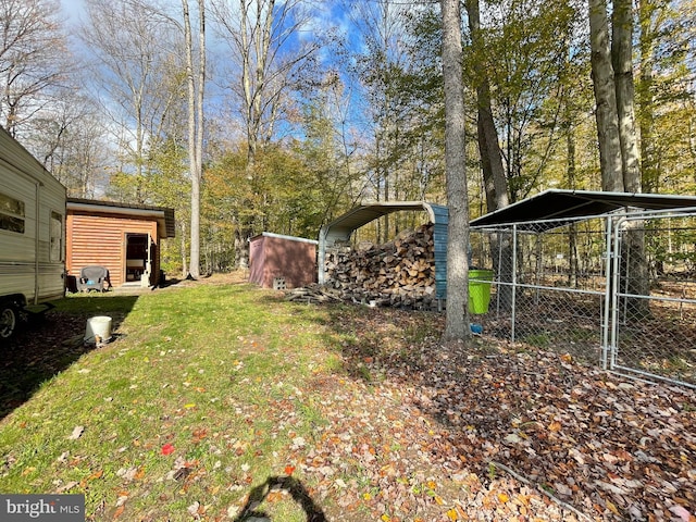 view of yard featuring a storage shed and a carport