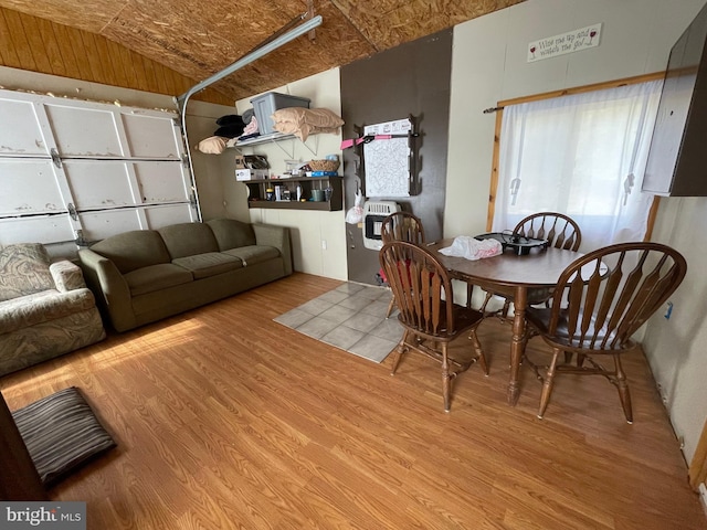 dining area featuring lofted ceiling and wood-type flooring