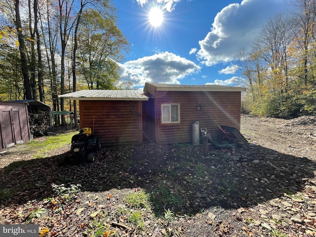 view of side of home with a shed