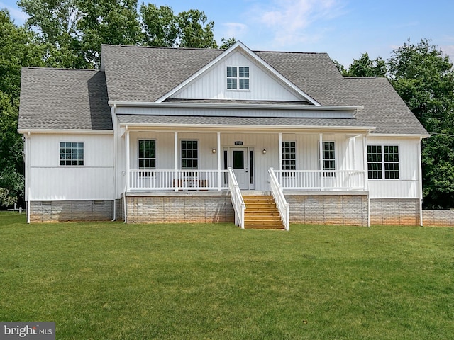 view of front of home with a front yard and covered porch