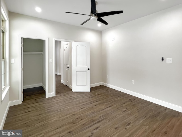 unfurnished bedroom featuring a closet, baseboards, recessed lighting, dark wood-style floors, and ceiling fan