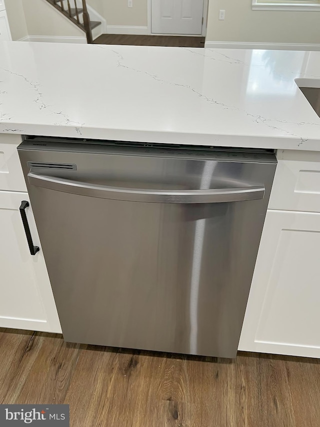 details with dark wood-style flooring, light countertops, and dishwasher