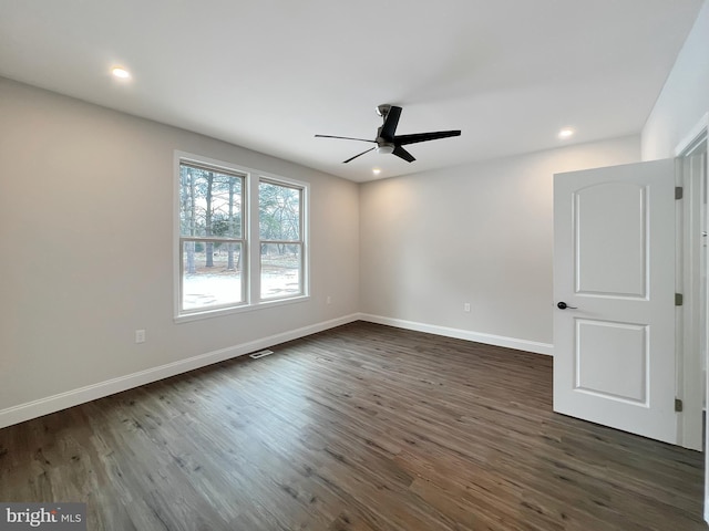 unfurnished room with dark wood-type flooring, baseboards, and ceiling fan