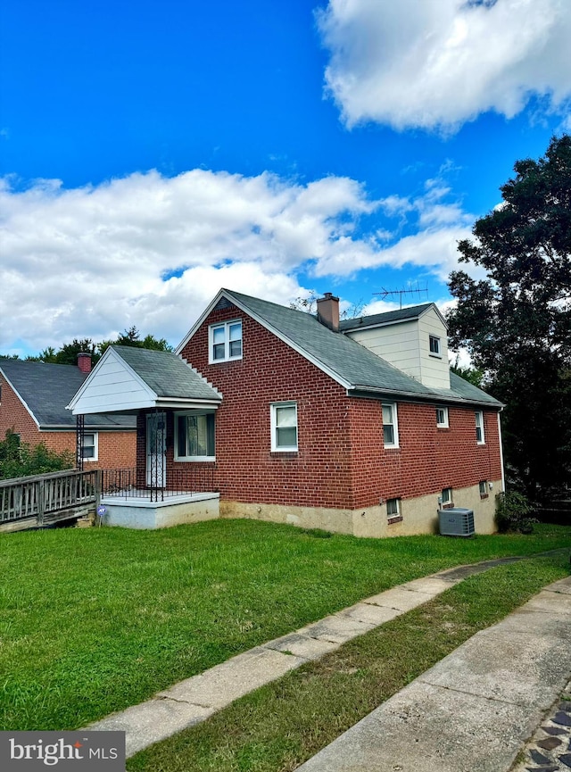 exterior space with covered porch, a yard, and central AC