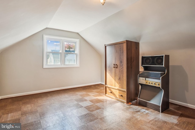 additional living space with parquet floors and vaulted ceiling