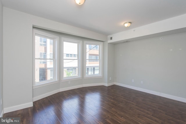 empty room featuring dark hardwood / wood-style flooring