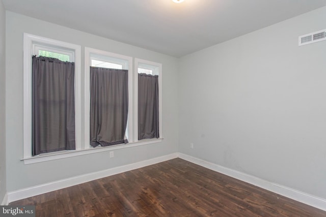 empty room with dark hardwood / wood-style floors