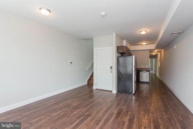interior space with dark wood-type flooring, visible vents, baseboards, and stairs