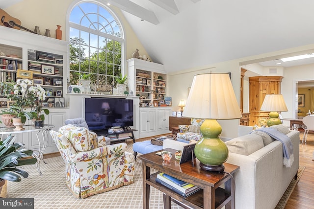 living room featuring beam ceiling, high vaulted ceiling, and wood-type flooring