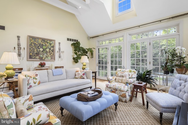 sunroom / solarium featuring visible vents, high vaulted ceiling, a healthy amount of sunlight, and french doors