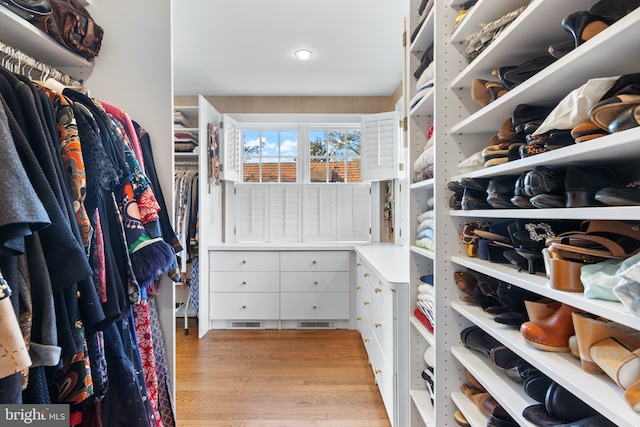spacious closet featuring visible vents and light wood-type flooring