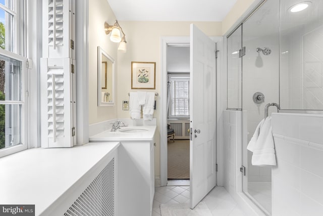 bathroom featuring vanity, tile patterned floors, and walk in shower