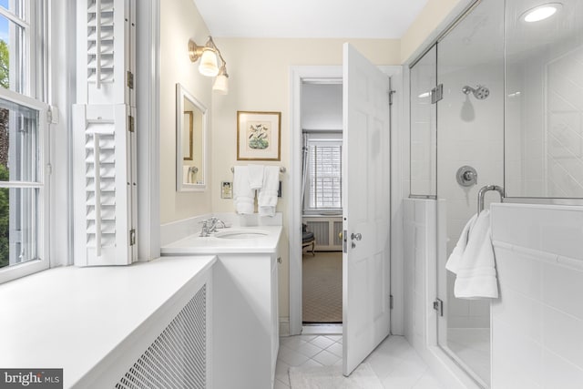 full bathroom with vanity, tile patterned floors, and a stall shower