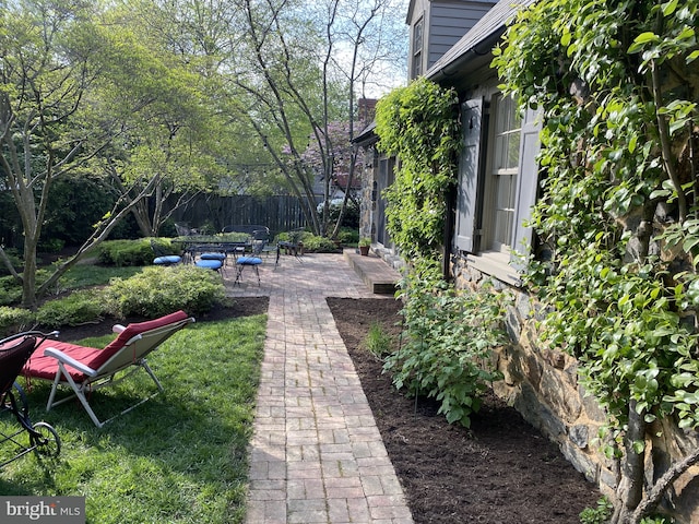 view of yard featuring fence and a patio