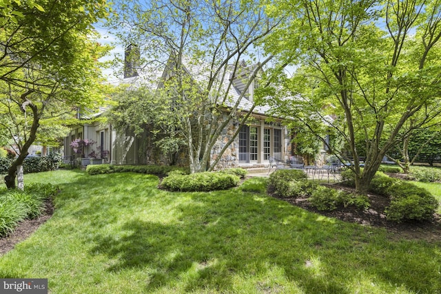 view of yard with a patio area and french doors