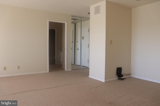 unfurnished room featuring carpet flooring