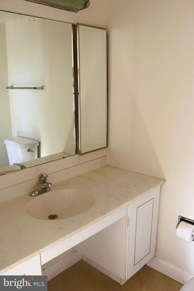 bathroom with vanity and toilet