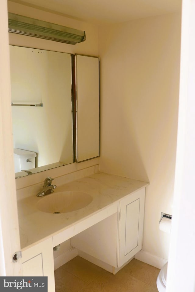 bathroom with vanity, toilet, and tile patterned flooring