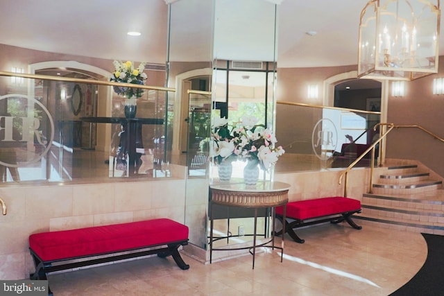 interior space featuring tile walls and a chandelier